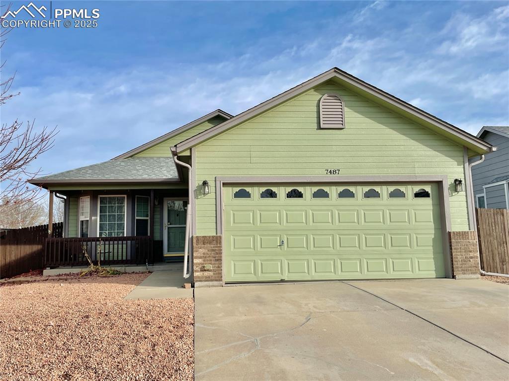 a front view of a house with garage