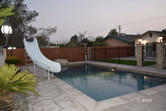 304 South Gateway Boulevard Ridgecrest, CA 93555 - Photo 26 of 30 a view of a swimming pool with a lounge chair