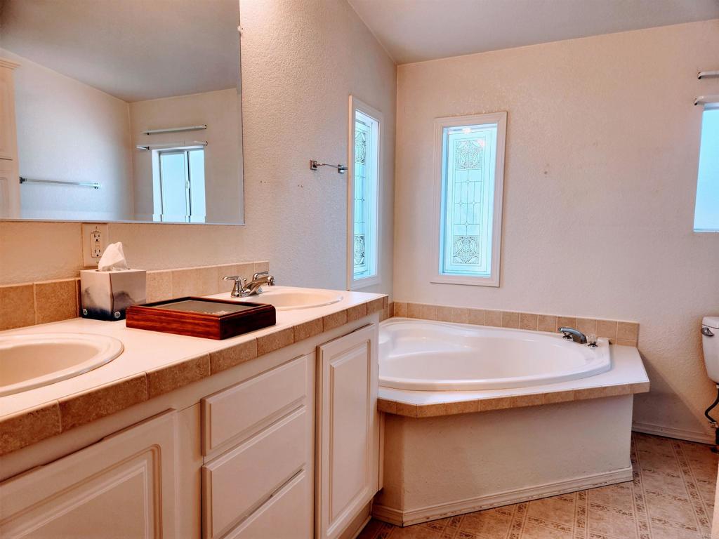 13217 Aurora Drive, Unit 41 El Cajon, CA 92021 - Photo 9 of 12 a bathroom with a sink and a bathtub