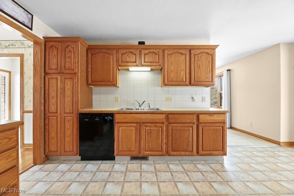 4808 Sherman Road Kent, OH 44240 - Photo 11 of 50 Kitchen featuring dishwasher, light countertops, brown cabinets, and tasteful backsplash