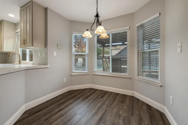 a view of a room with wooden floors and windows