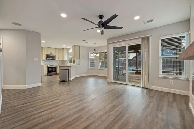 a view of a kitchen with wooden floor and a kitchen