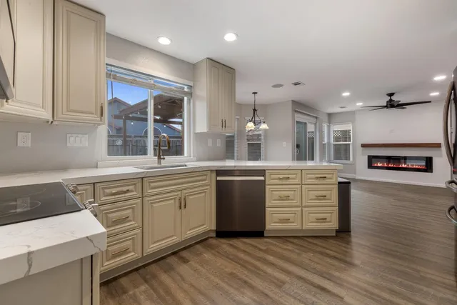 a large kitchen with stainless steel appliances granite countertop a stove and a sink