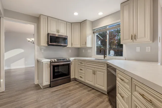 a kitchen with stainless steel appliances granite countertop a stove and a sink