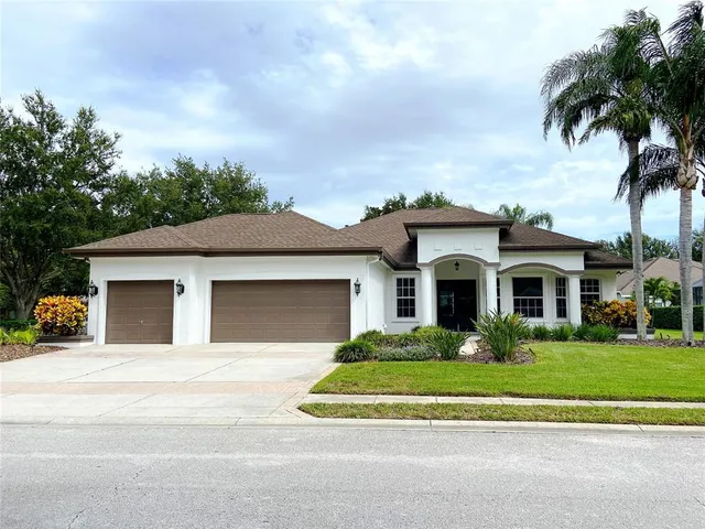 a kitchen with granite countertop a center island stainless steel appliances cabinets and a window