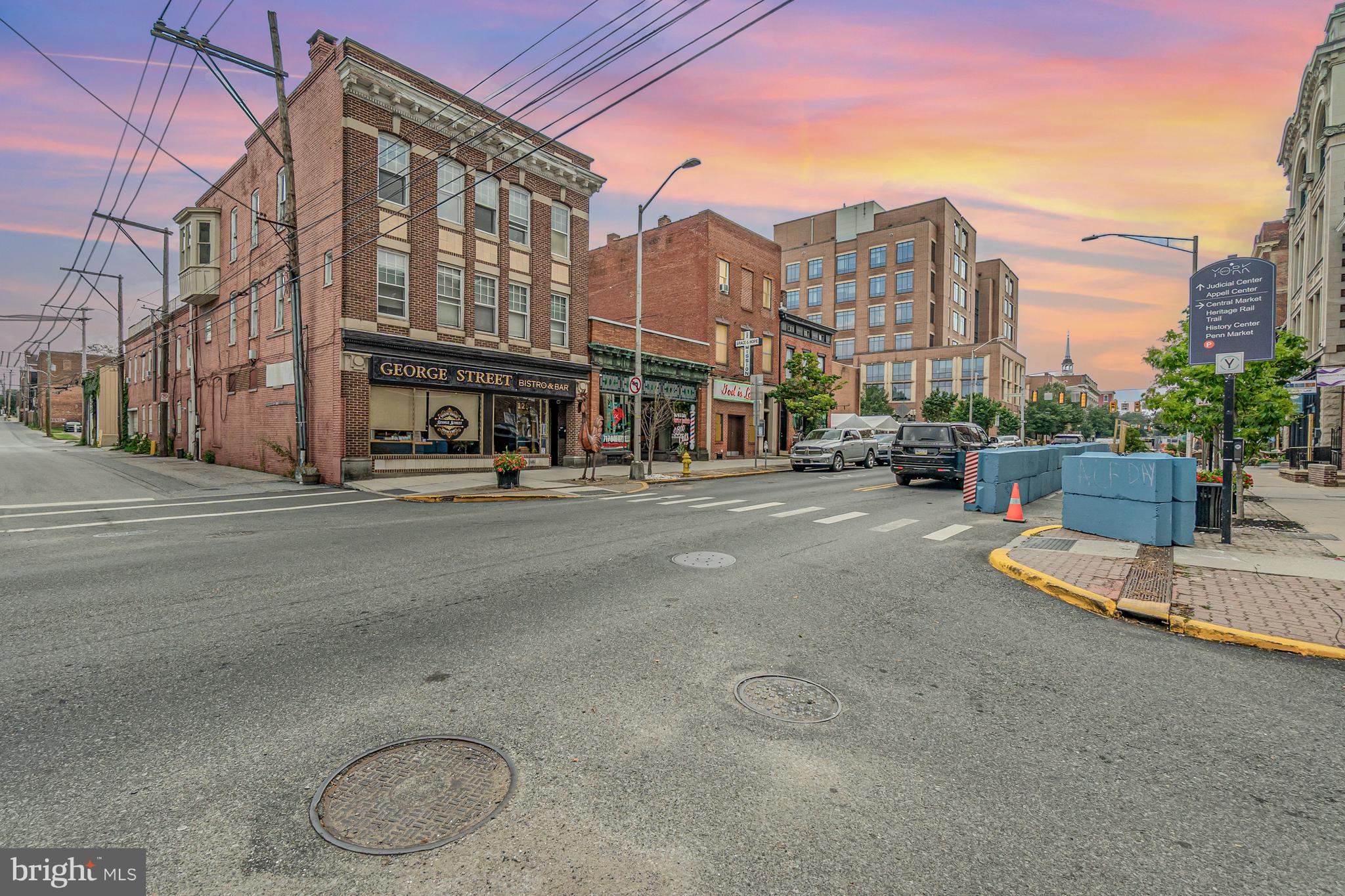 a view of a city street with tall buildings