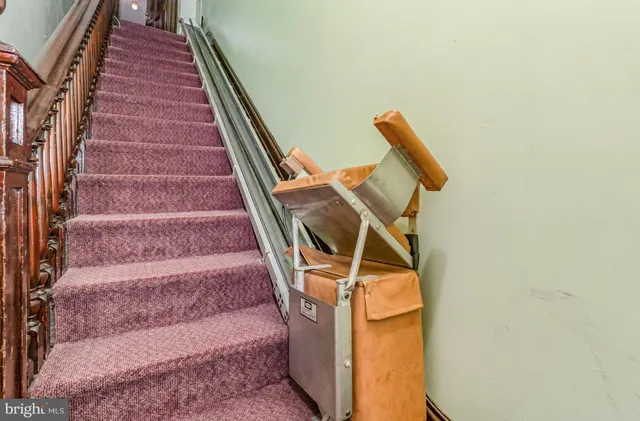 a bathroom with a granite countertop toilet sink and mirror