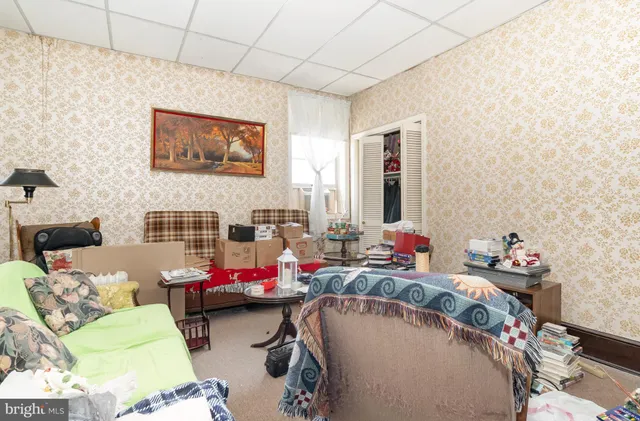 a spacious bedroom with a bed and a chandelier