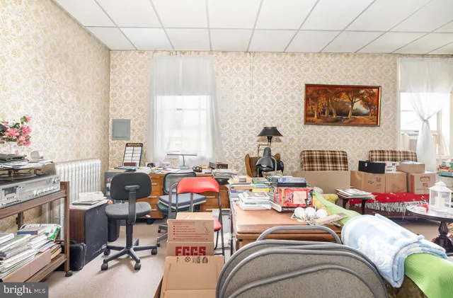 a dining room with a table chairs and a kitchen
