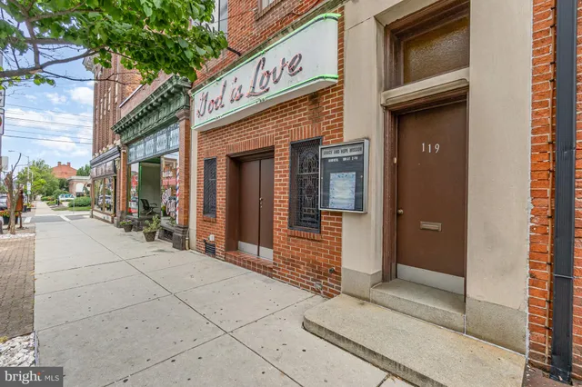 a view of an entryway with a table and chairs