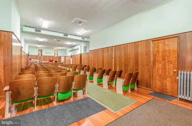 a view of a dining room with furniture and a window