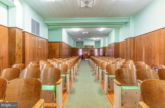 a view of a hallway with wooden floor and entryway