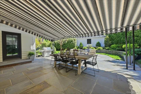a view of a patio with a dining table and chairs with a patio