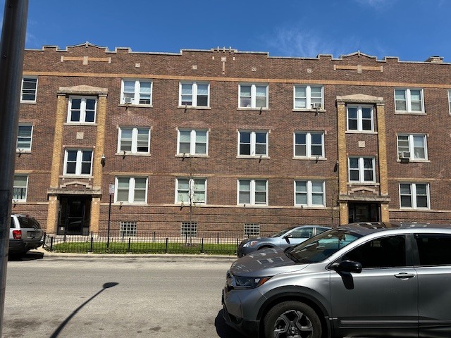 4058 West Dickens Avenue, Unit 2D Chicago, IL 60639 - Photo 1 of 10 a front view of a house with car parked