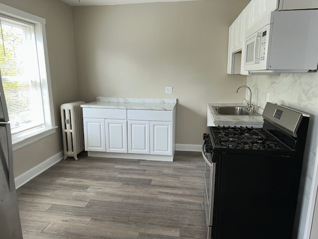 4058 West Dickens Avenue, Unit 2D Chicago, IL 60639 - Photo 6 of 10 a kitchen with a refrigerator stove and a sink