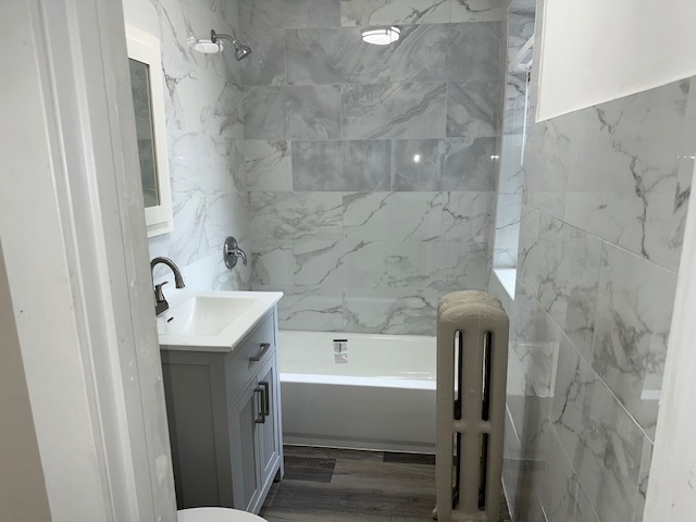4058 West Dickens Avenue, Unit 2D Chicago, IL 60639 - Photo 8 of 10 a bathroom with a sink a mirror and a bathtub