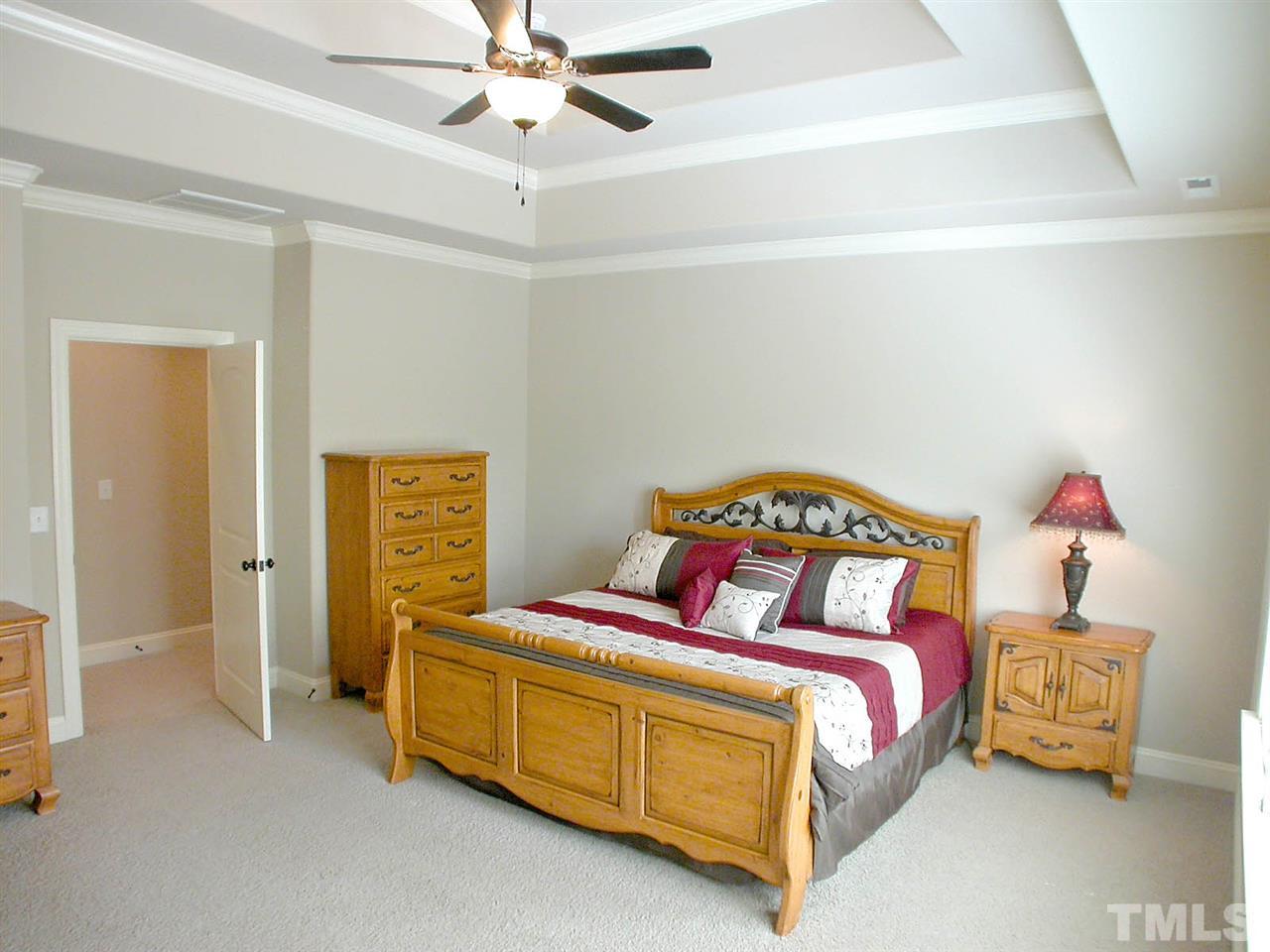 12349 Beestone Lane Raleigh, NC 27614 - Photo 12 of 25 a bedroom with a bed and a chandelier