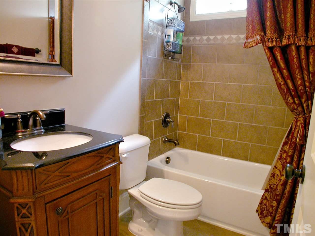 12349 Beestone Lane Raleigh, NC 27614 - Photo 17 of 25 a bathroom with a sink toilet and shower