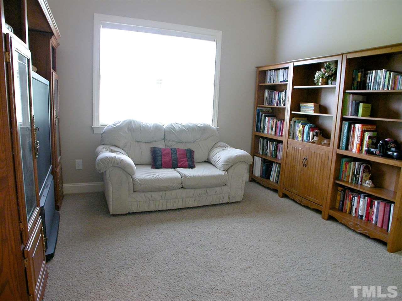12349 Beestone Lane Raleigh, NC 27614 - Photo 19 of 25 a living room with furniture and a book shelf