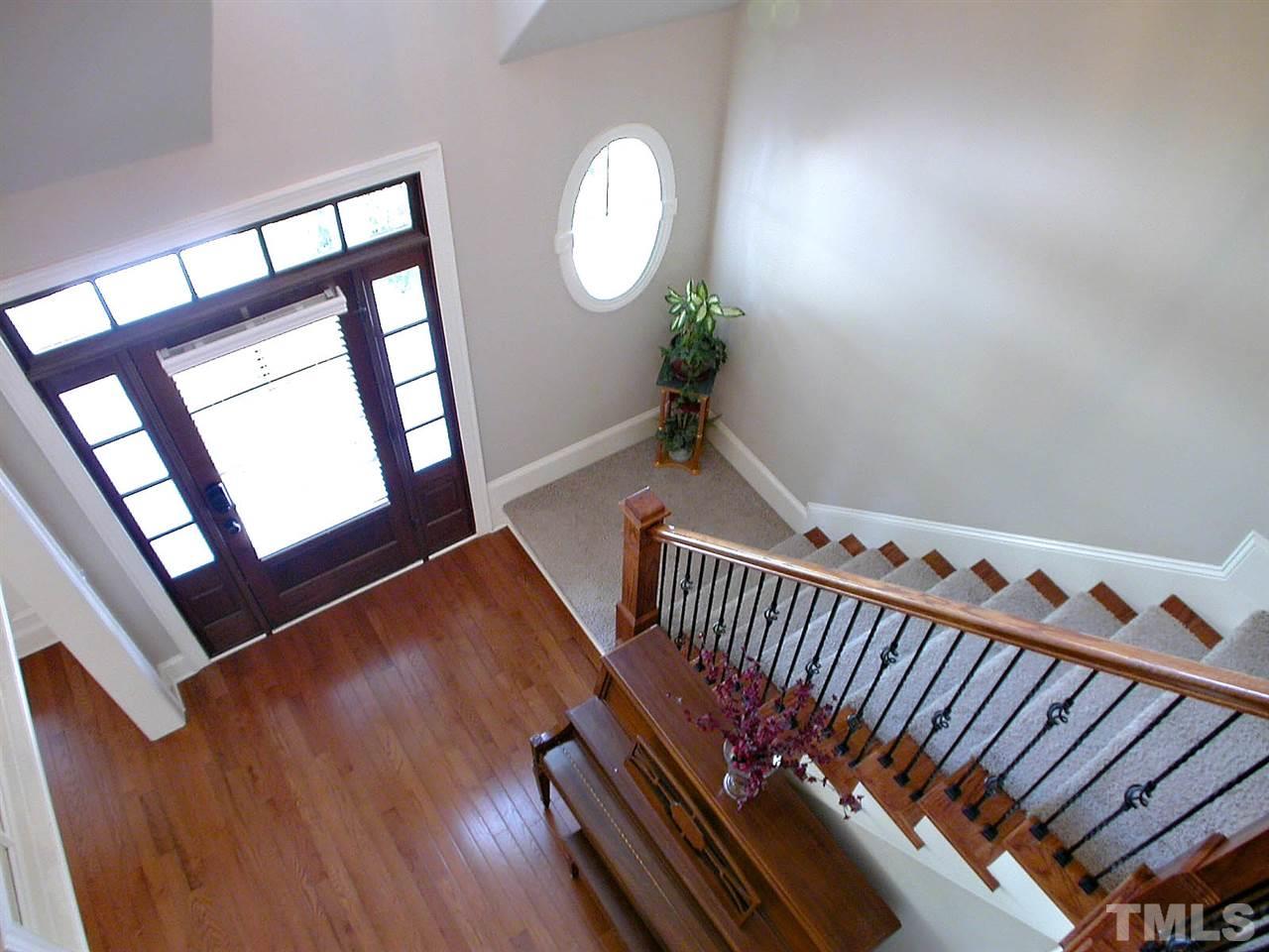 12349 Beestone Lane Raleigh, NC 27614 - Photo 3 of 25 a view of an empty room with wooden floor and stairs