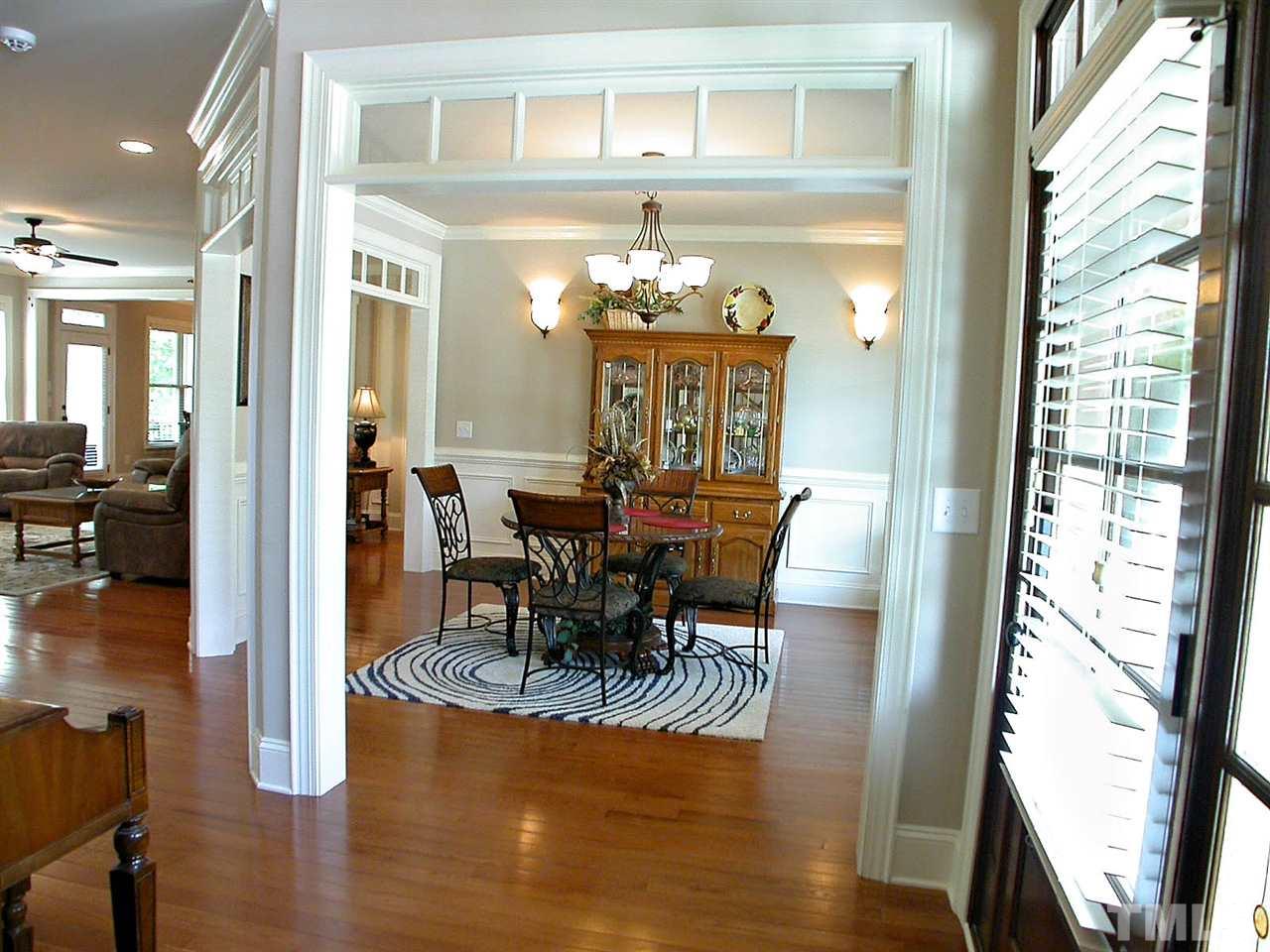 12349 Beestone Lane Raleigh, NC 27614 - Photo 4 of 25 a view of a dining room with furniture window and wooden floor