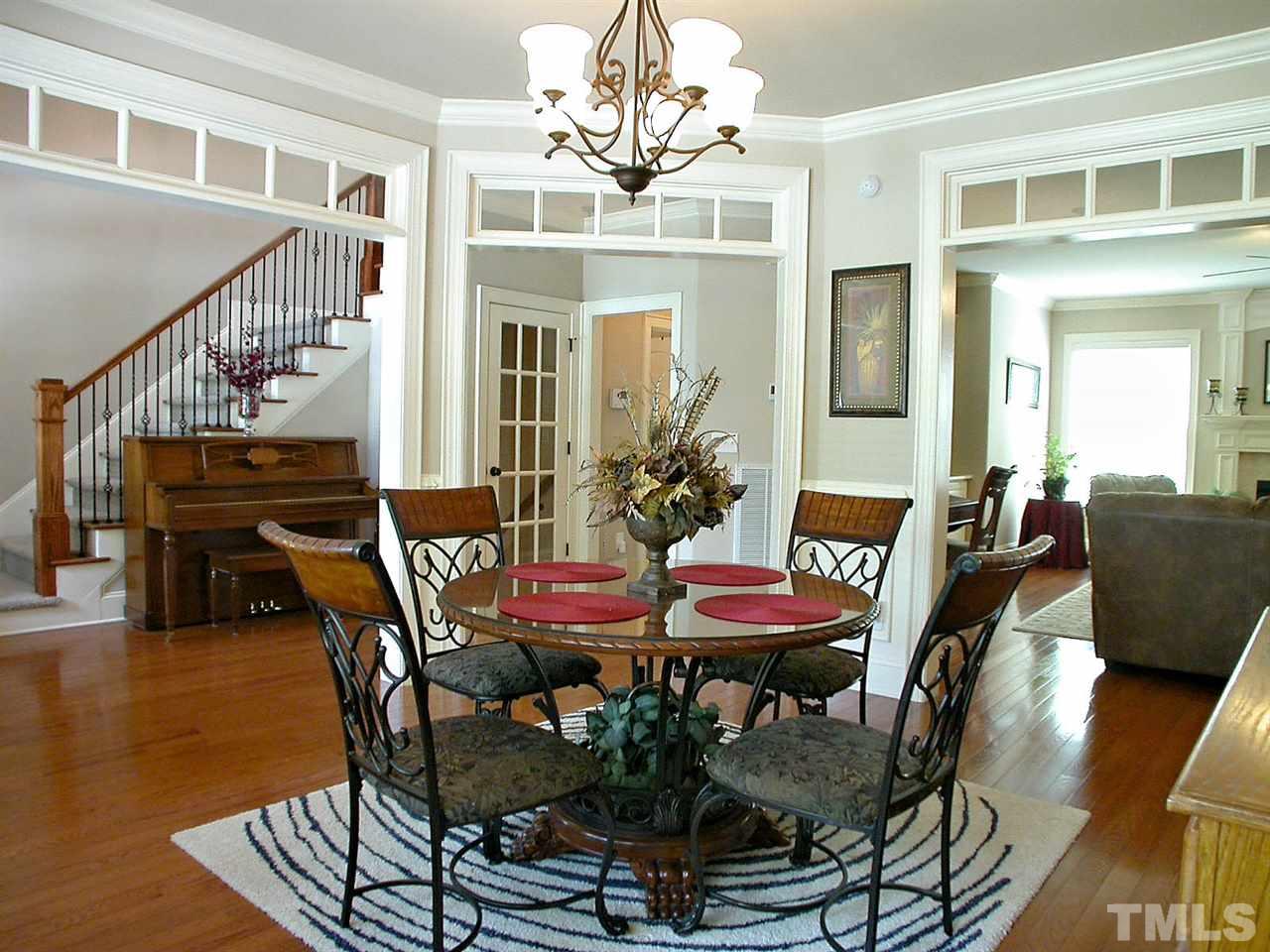 12349 Beestone Lane Raleigh, NC 27614 - Photo 5 of 25 a view of a dining room with furniture wooden floor and chandelier