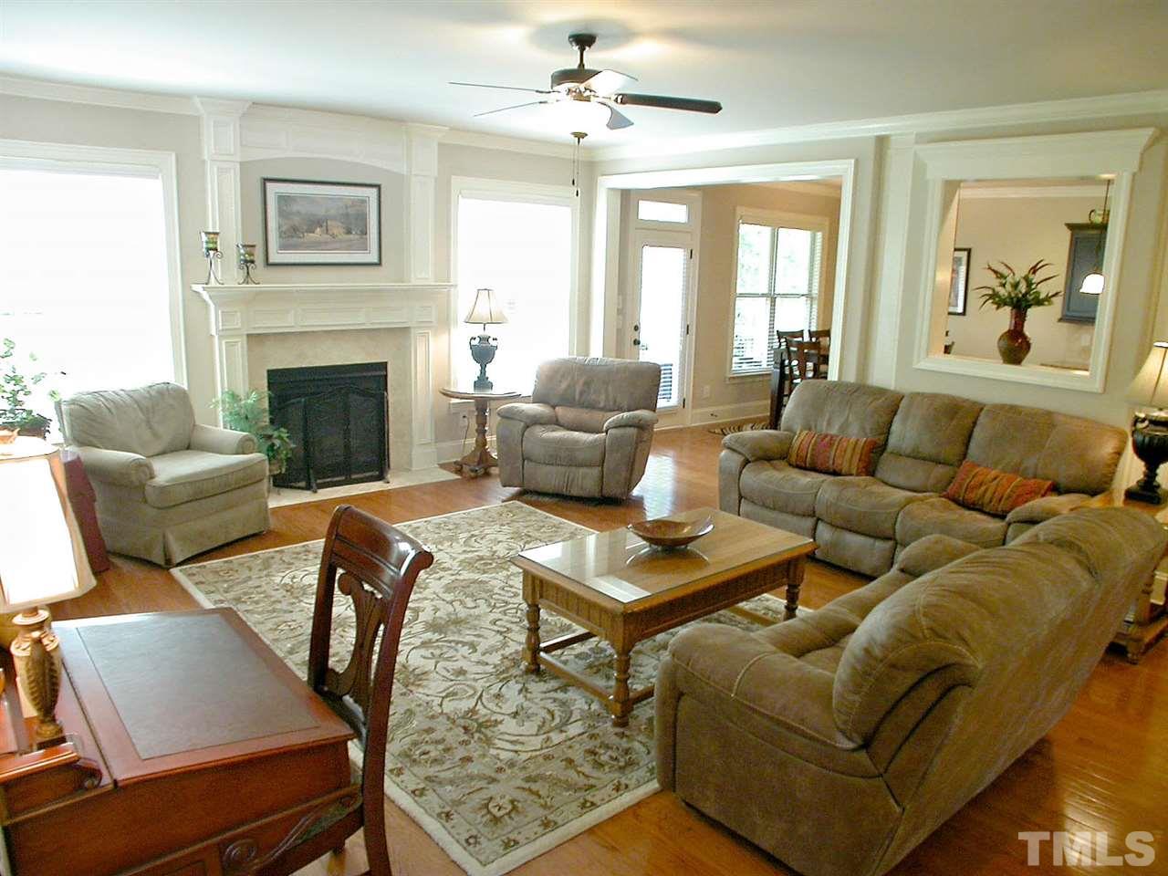 12349 Beestone Lane Raleigh, NC 27614 - Photo 6 of 25 a living room with furniture fireplace and a large window