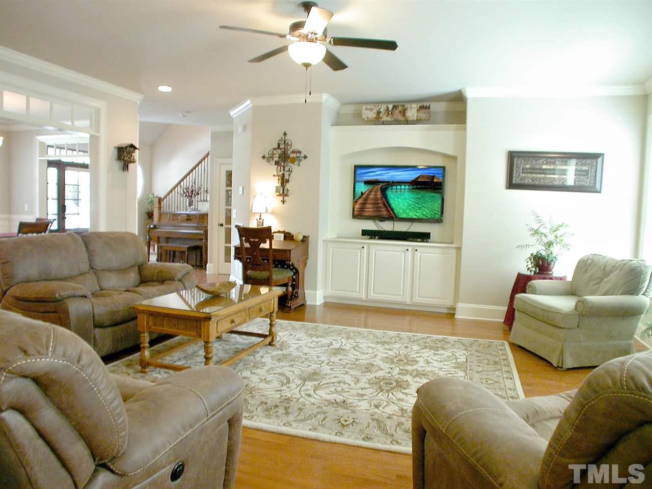 12349 Beestone Lane Raleigh, NC 27614 - Photo 7 of 25 a living room with furniture and a flat screen tv