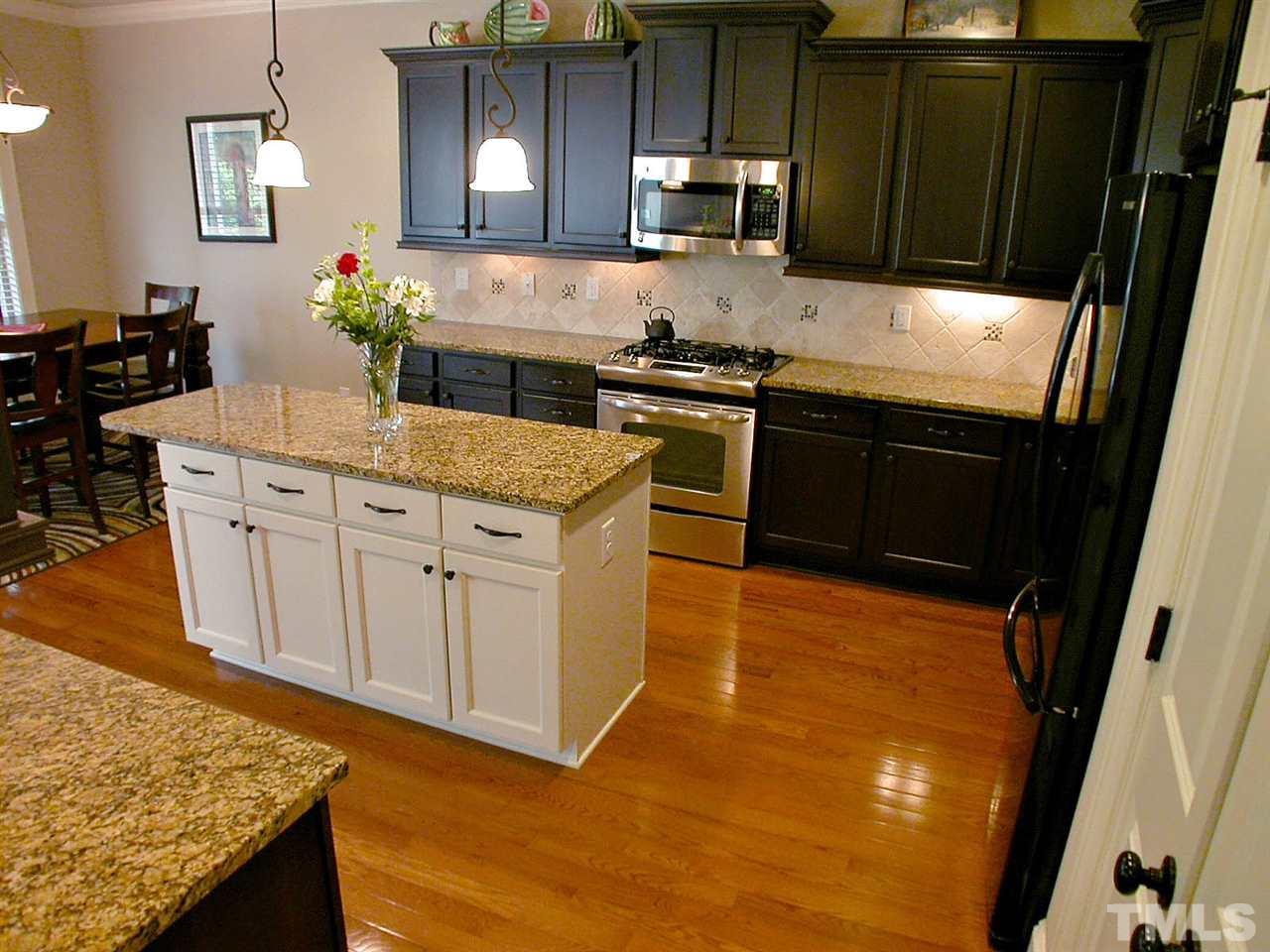 12349 Beestone Lane Raleigh, NC 27614 - Photo 10 of 25 a kitchen with granite countertop a sink and cabinets
