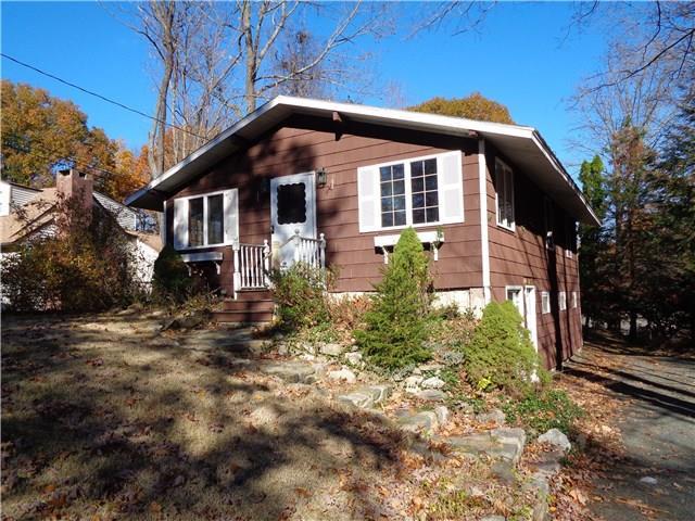 102 Lakeside Drive Ridgefield, CT 06877 - Photo 1 of 1 a front view of a house with garden