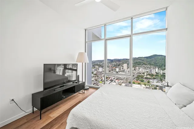 a living room with a large window and a flat screen tv