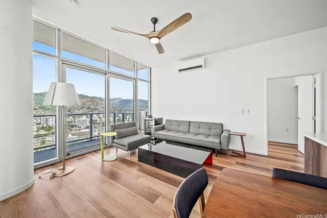 a living room with furniture and a floor to ceiling window