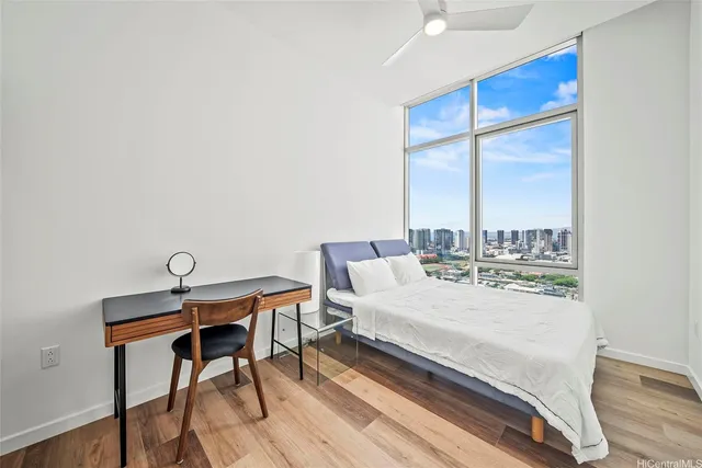 a bedroom with a bed and a desk