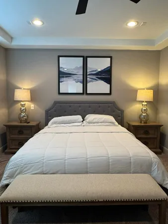 a bedroom with a bed and a night stand