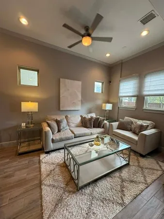 a view of a dining room with furniture and wooden floor