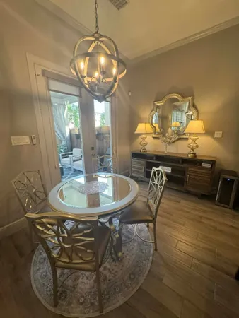a kitchen with a table chairs refrigerator and microwave