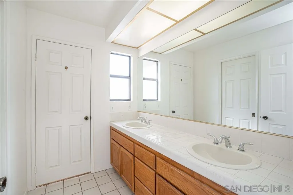 8549 Circle R Valley Lane Escondido, CA 92026 - Photo 11 of 25 a bathroom with a sink and a mirror