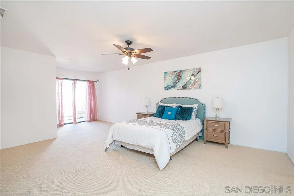 8549 Circle R Valley Lane Escondido, CA 92026 - Photo 12 of 25 a bedroom with a bed and a chandelier