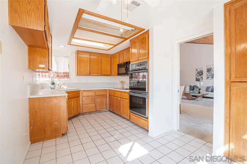 8549 Circle R Valley Lane Escondido, CA 92026 - Photo 20 of 25 a kitchen with a sink cabinets and appliances