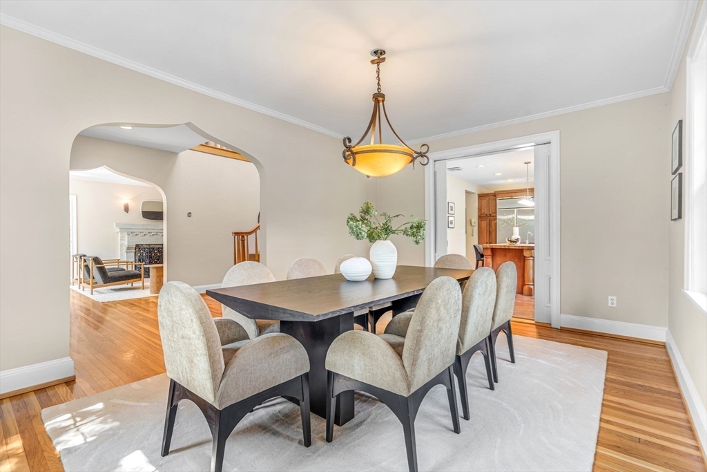 27 Newell Road, Unit 2 Brookline, MA 02446 - Photo 11 of 41 a view of a dining room and livingroom with furniture wooden floor a chandelier