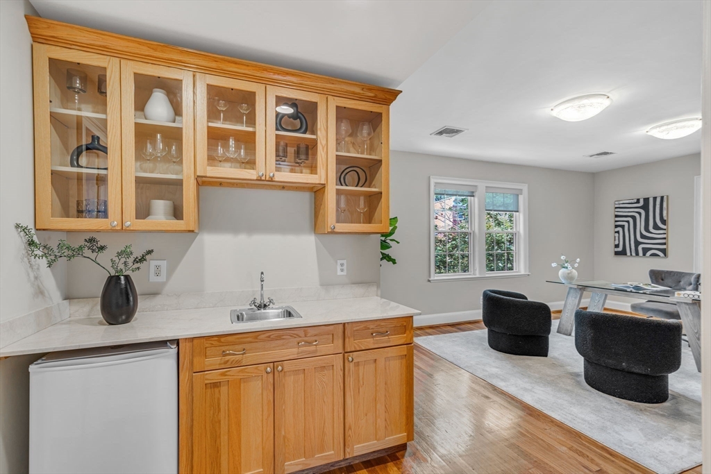 27 Newell Road, Unit 2 Brookline, MA 02446 - Photo 12 of 41 a kitchen with a sink and wooden cabinets