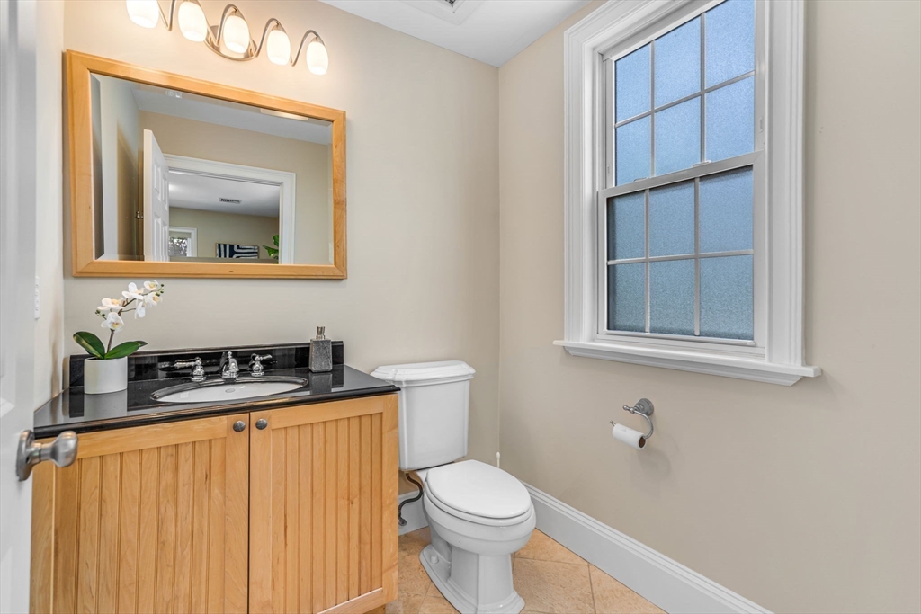 27 Newell Road, Unit 2 Brookline, MA 02446 - Photo 16 of 41 a bathroom with a toilet a sink and mirror