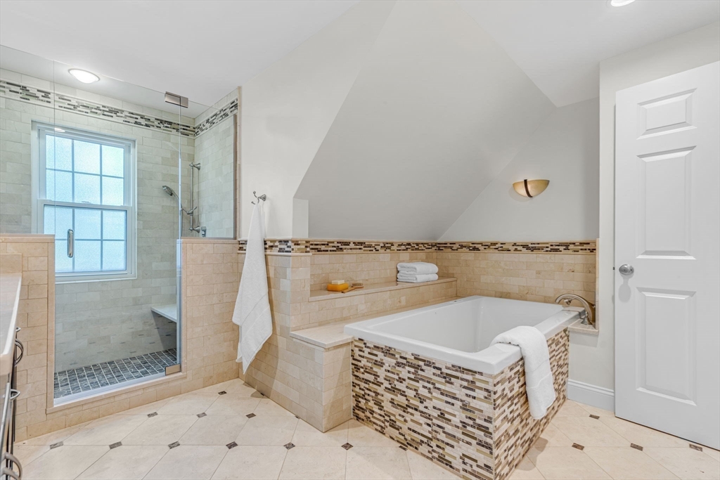 27 Newell Road, Unit 2 Brookline, MA 02446 - Photo 28 of 41 a bathroom with a tub a sink and glass door