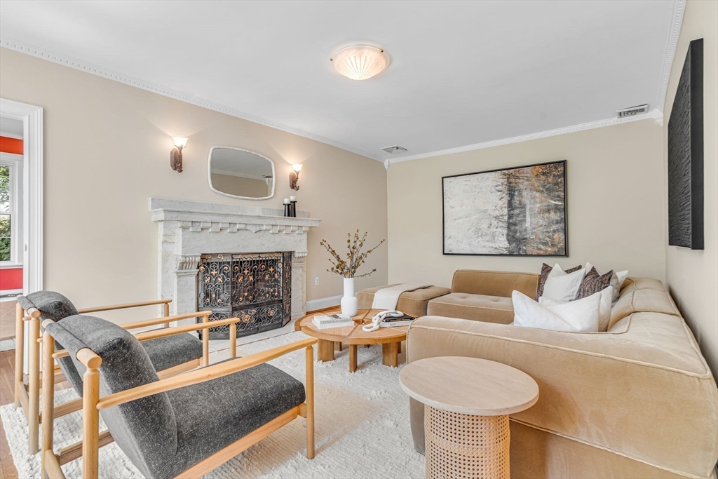 27 Newell Road, Unit 2 Brookline, MA 02446 - Photo 3 of 41 a living room with furniture and a fireplace