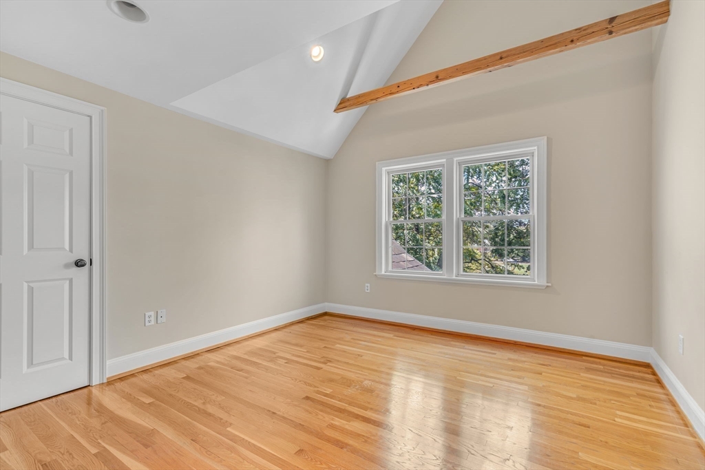 27 Newell Road, Unit 2 Brookline, MA 02446 - Photo 31 of 41 a view of an empty room with wooden floor and a window