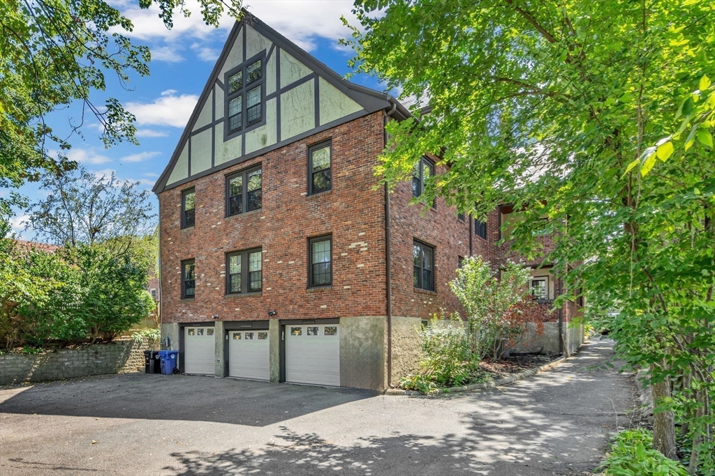 27 Newell Road, Unit 2 Brookline, MA 02446 - Photo 40 of 41 a view of a house with a yard and tree s