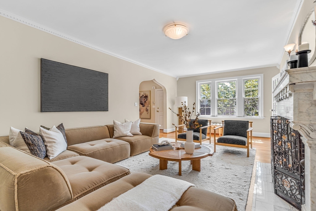 27 Newell Road, Unit 2 Brookline, MA 02446 - Photo 4 of 41 a living room with furniture a fireplace and a flat screen tv