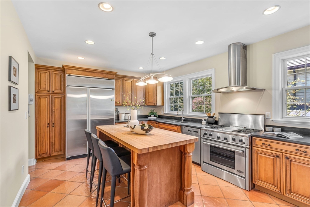 27 Newell Road, Unit 2 Brookline, MA 02446 - Photo 8 of 41 a kitchen with stainless steel appliances granite countertop a stove a sink dishwasher and a refrigerator with wooden floor