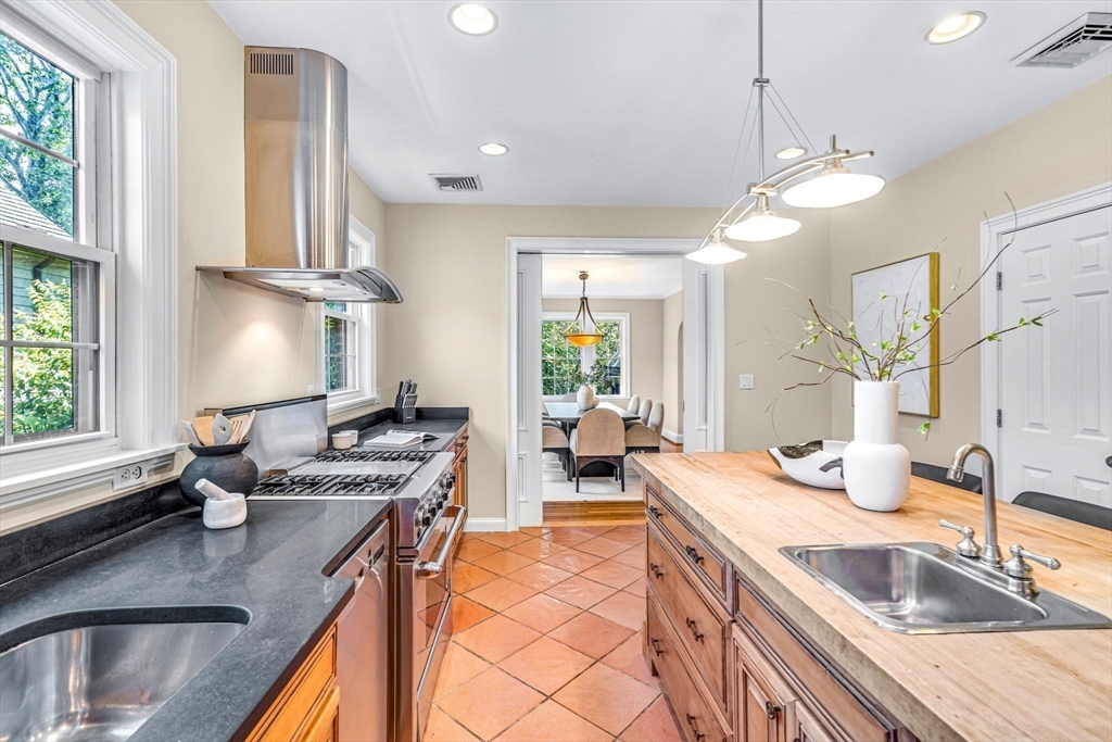 27 Newell Road, Unit 2 Brookline, MA 02446 - Photo 10 of 41 a kitchen with stainless steel appliances granite countertop a sink a stove and a wooden floors