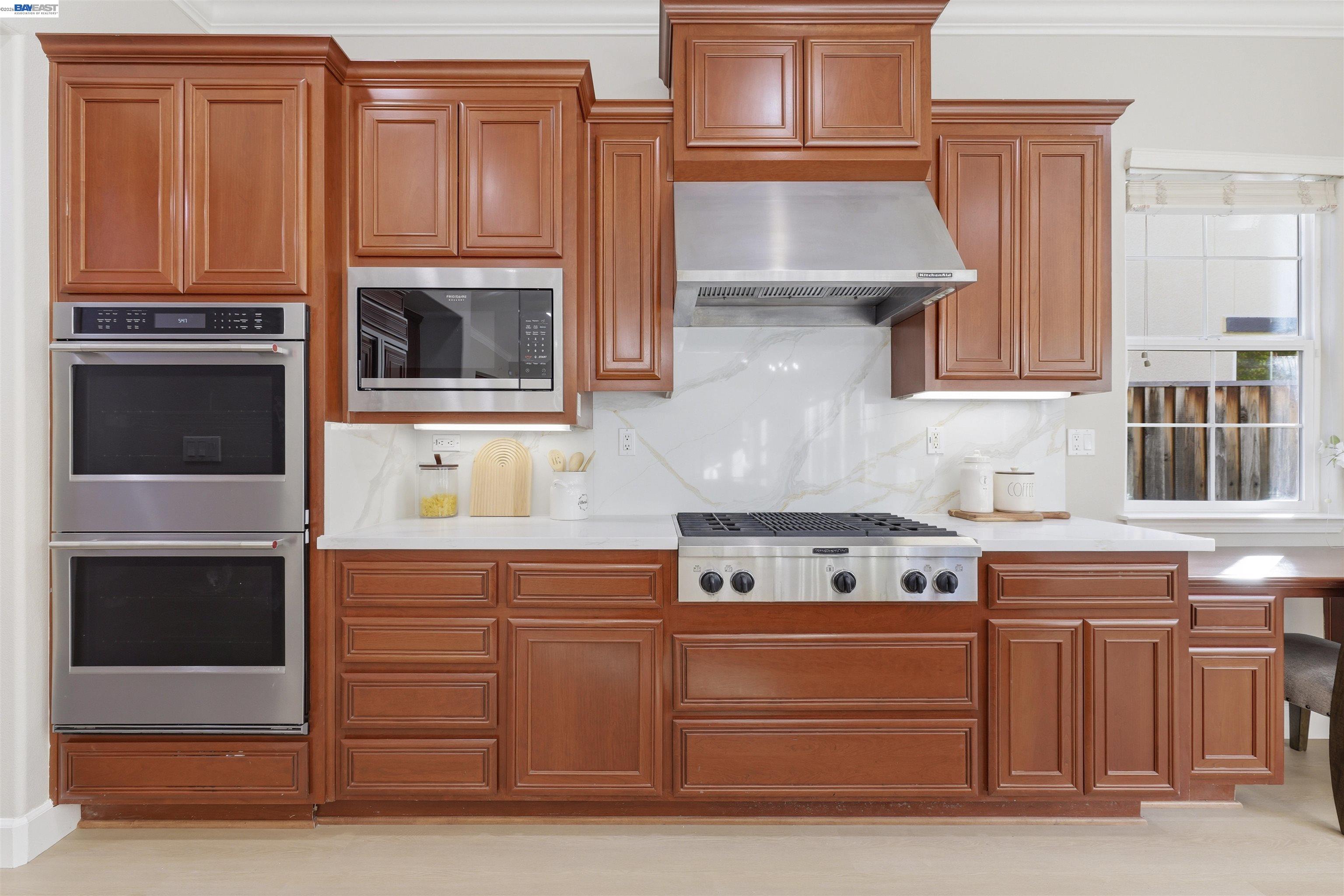 116 Macedon Court San Ramon, CA 94582 - Photo 17 of 60 a kitchen with stainless steel appliances granite countertop a stove and a microwave